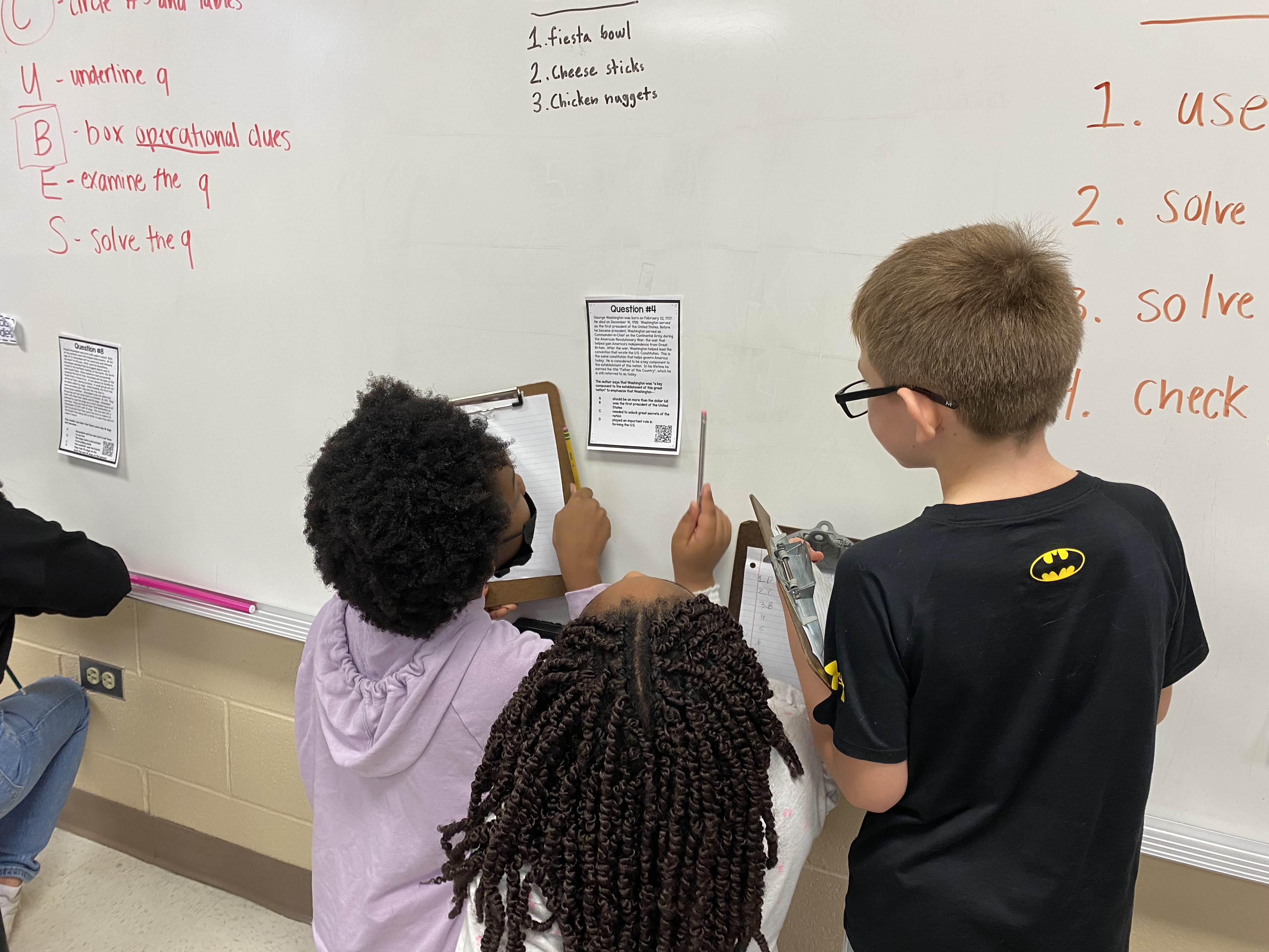 Students at a white board. 