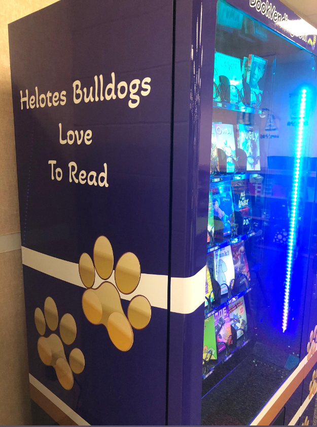 Pic of left side of Book Vending Machine with "Helotes Bulldogs Love To Read" quote and bulldog paws
