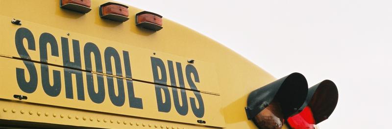 Close up image of the top of a yellow school bus