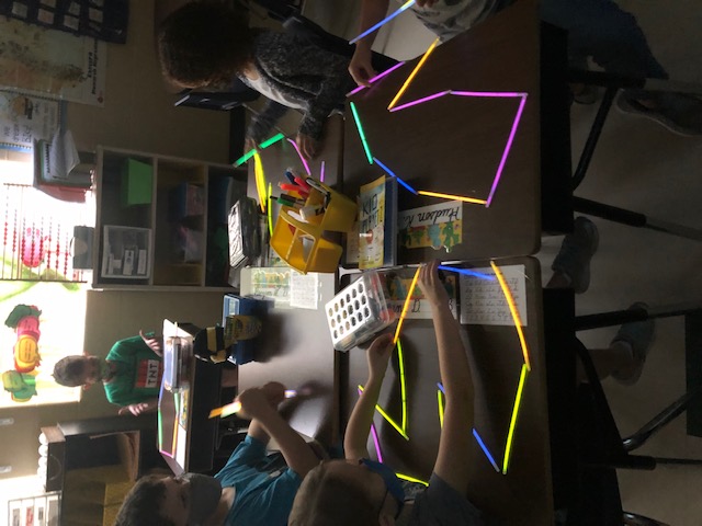 Students building with light sticks.