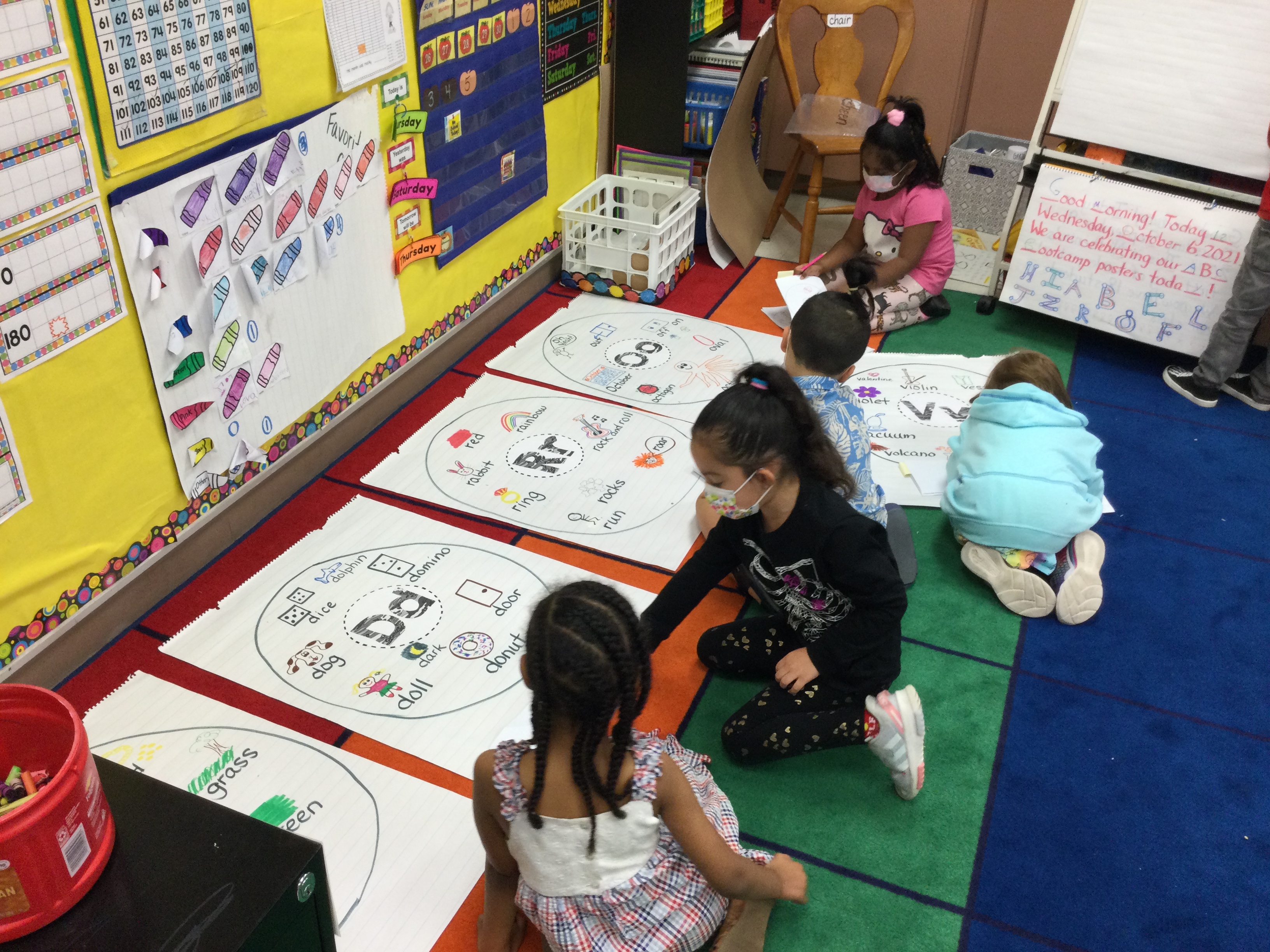 Students drawing letters