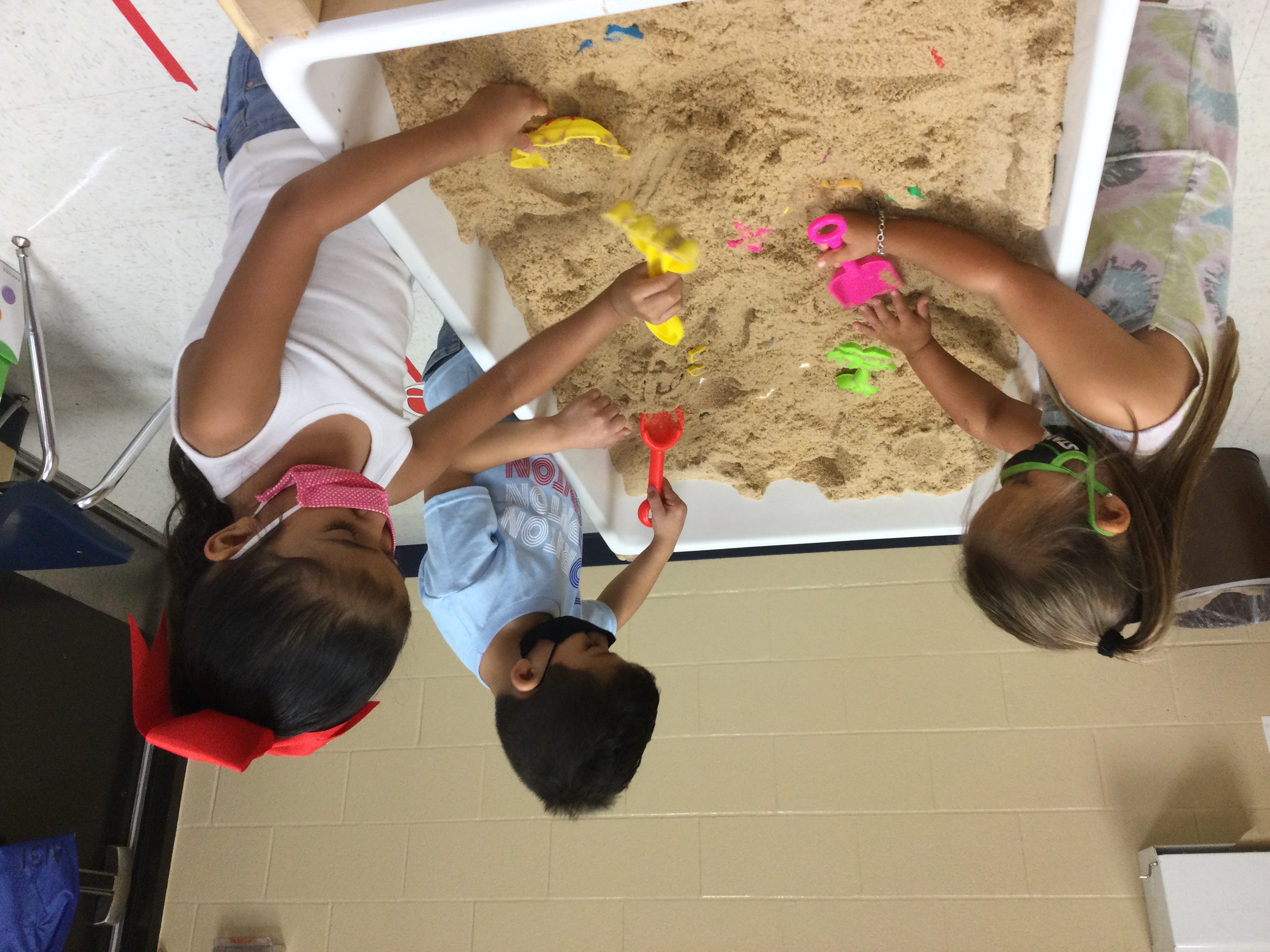 Students playing with sand.