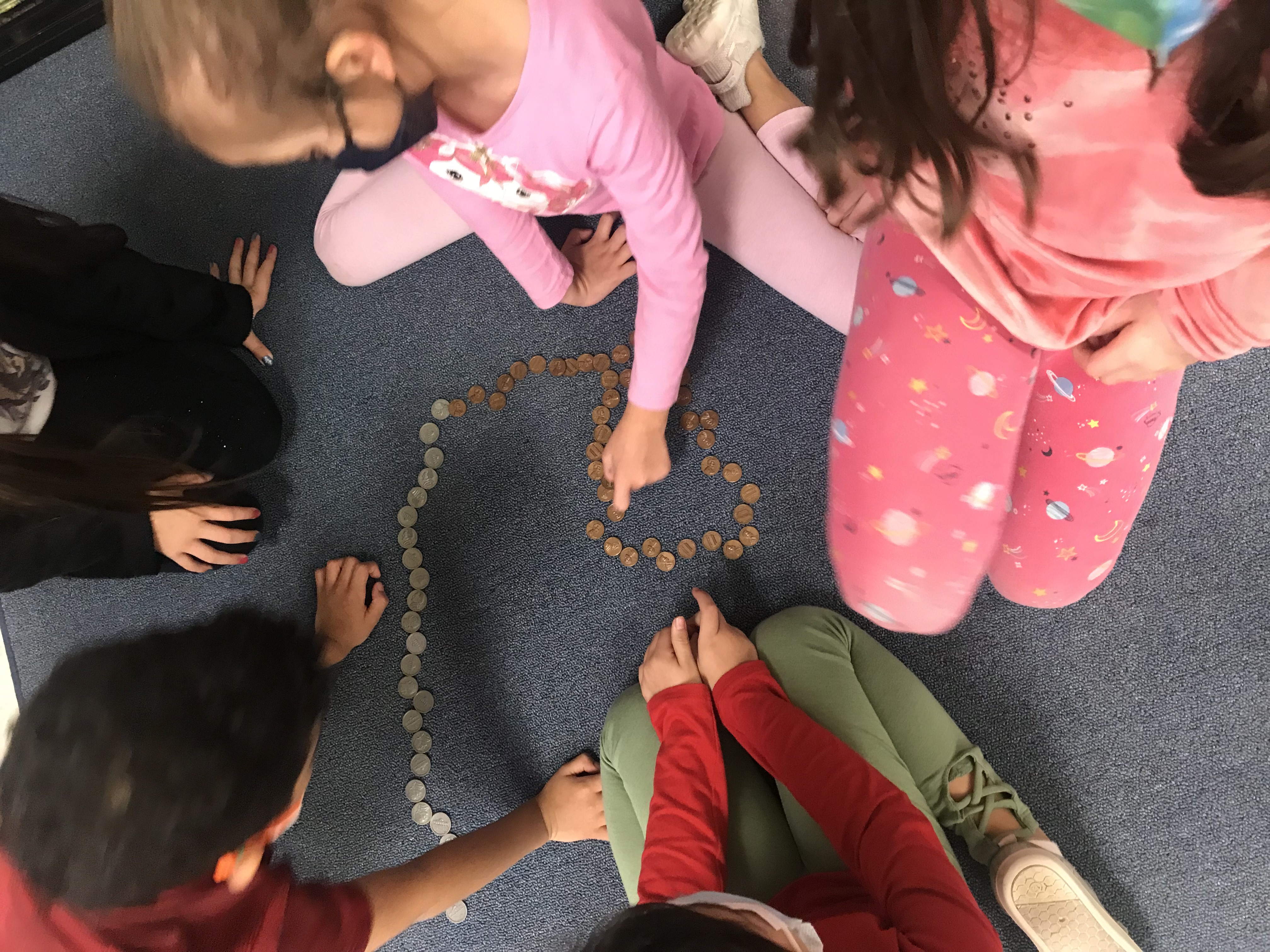 Students counting coins. 