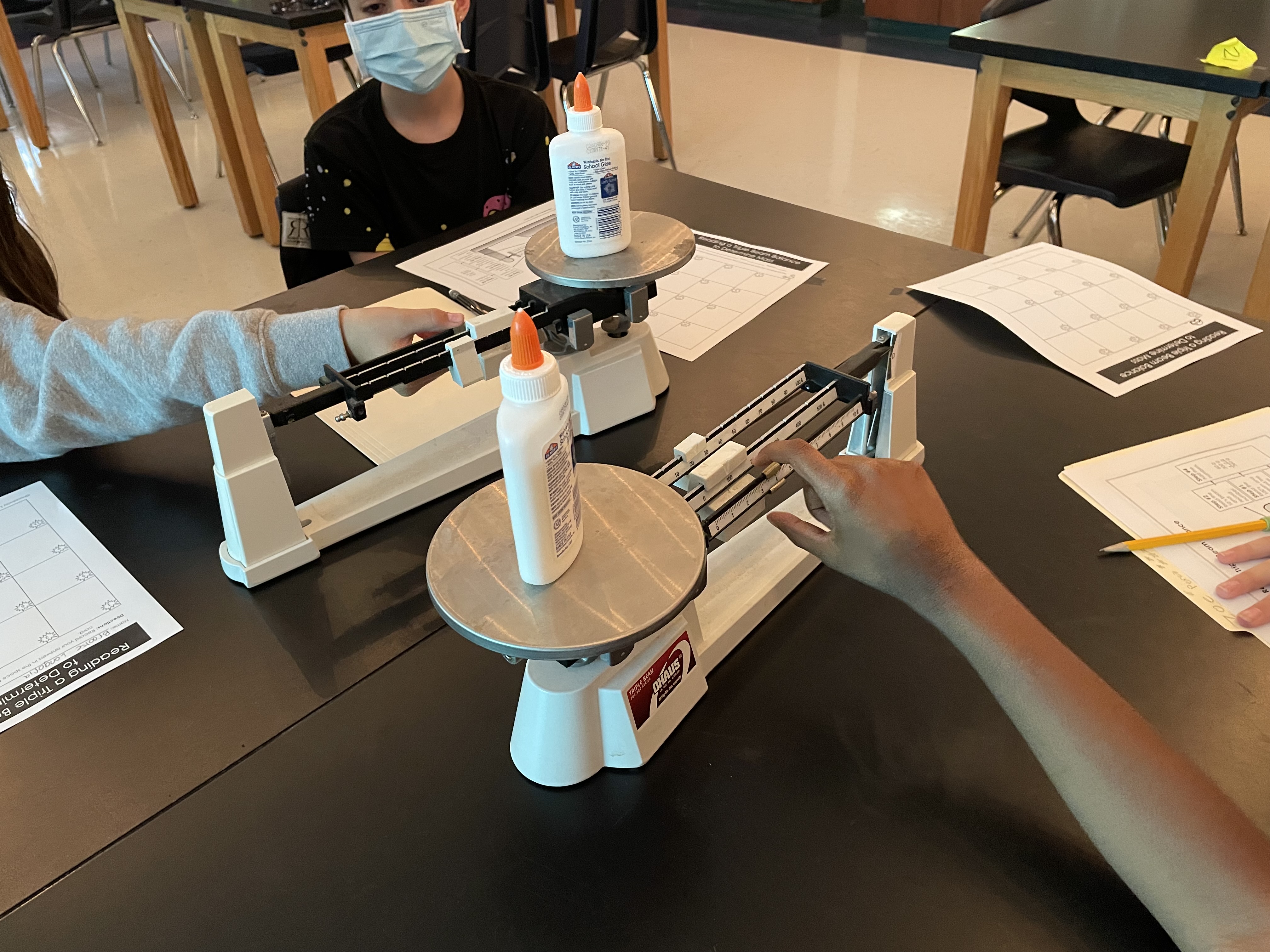 Measuring weight on a triple beam balance