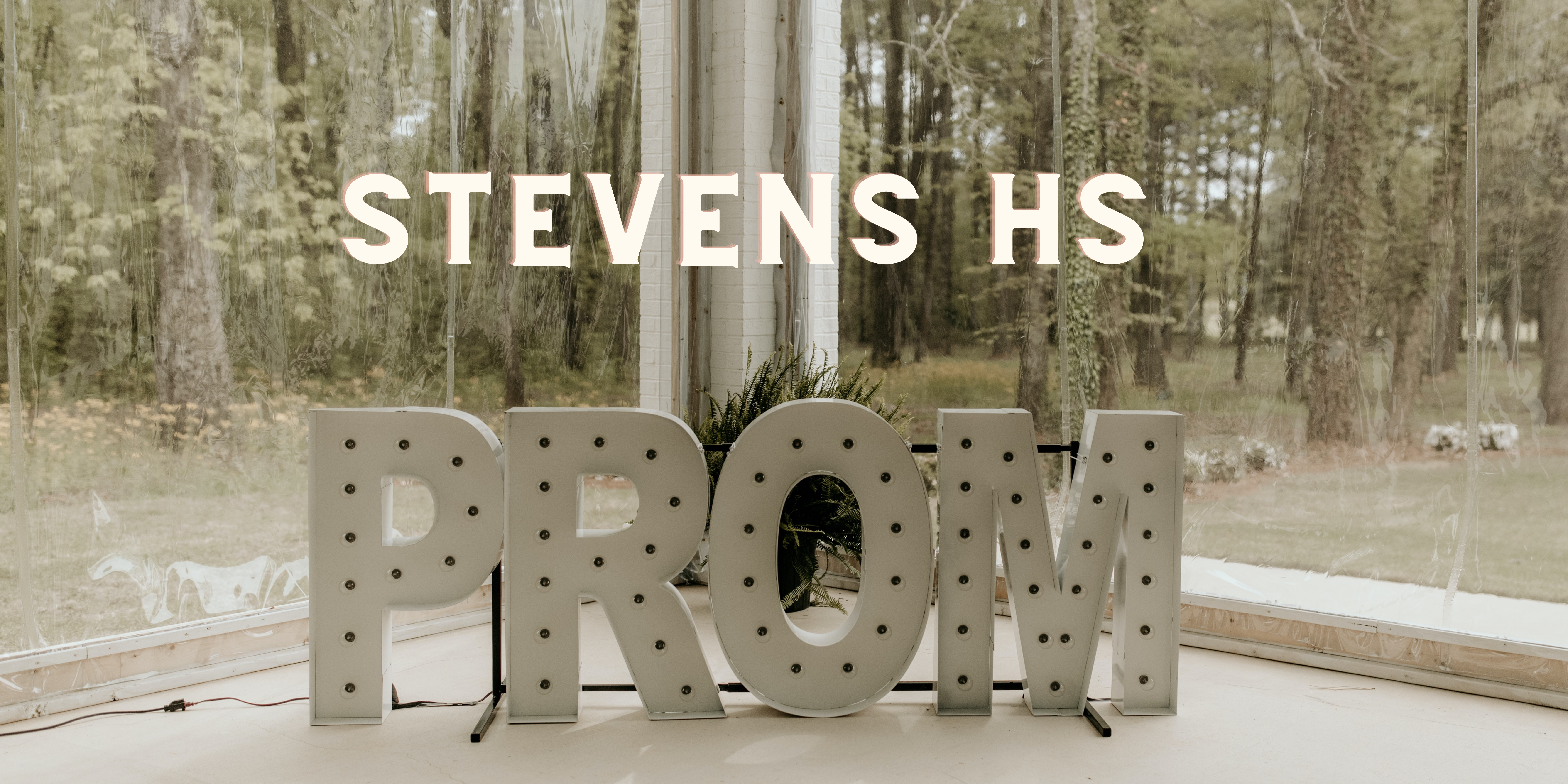 Letters forming the word prom in front of a forest