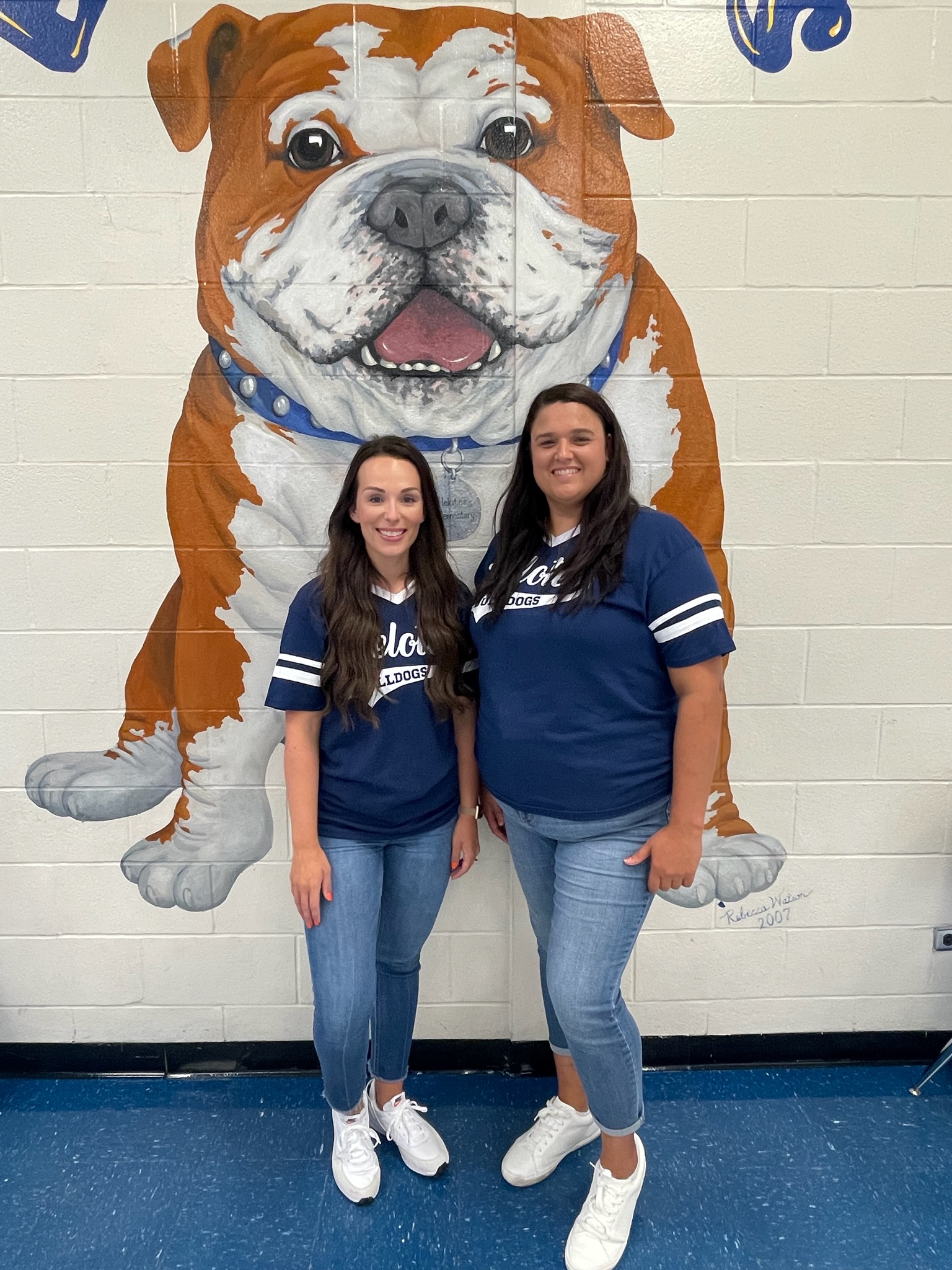 Pic of second grade teachers in front of bulldog mural