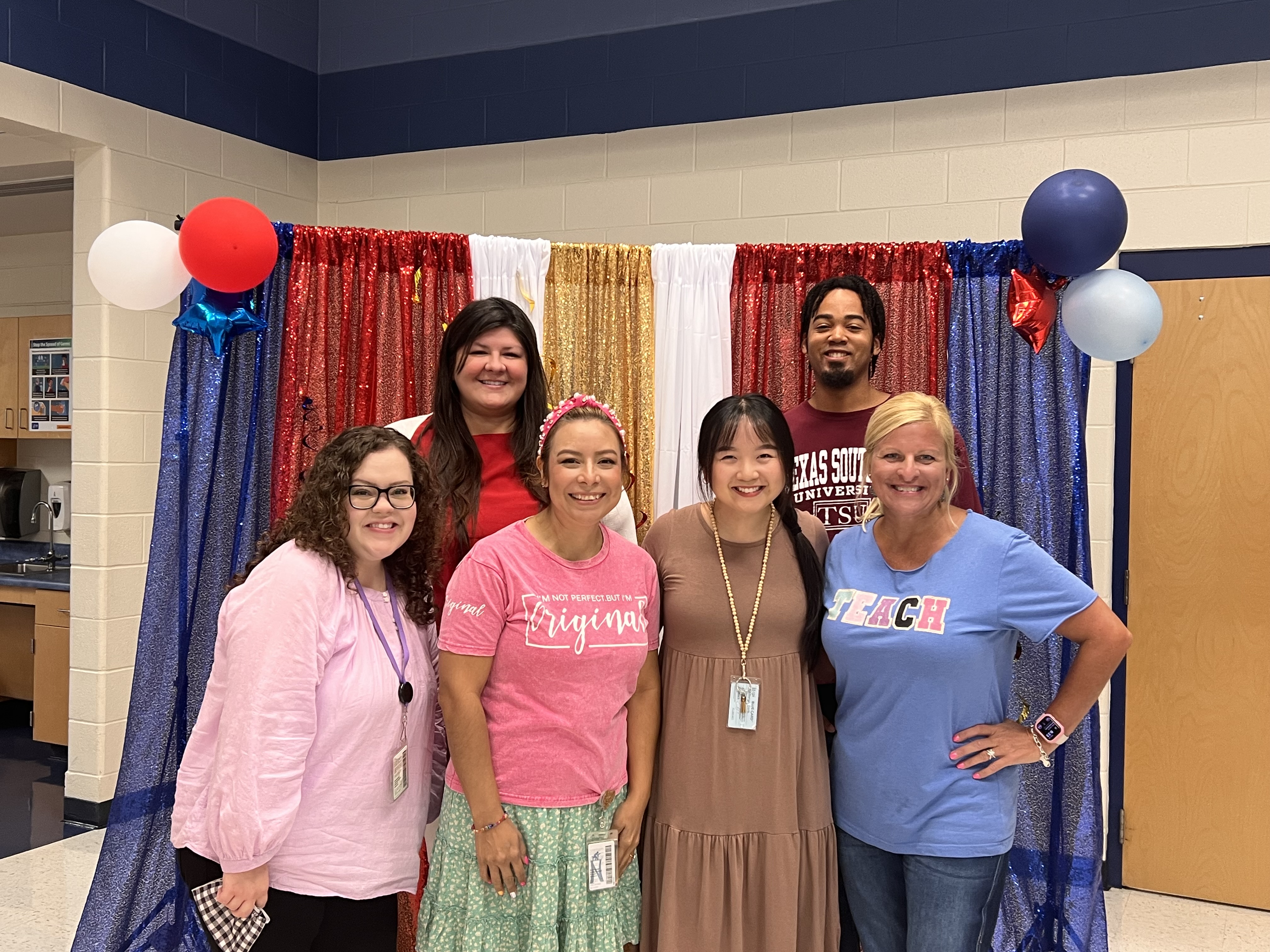 Ms. Hanhart, Ms. Riedl, Ms. Fregeau, Ms. Finley, Ms. Lindsey, Mr. McCulloch, on a rainbow background smiling and happy to teach second grade Ms. Dore