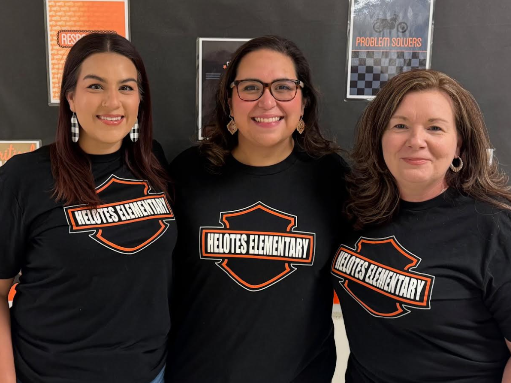 Pic of Helotes Elementary Fourth Grade Team in front of bulletin board