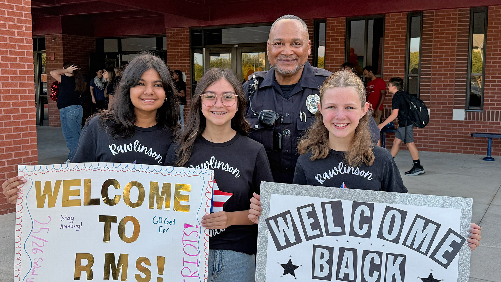 Officer with students, first day of school 2025