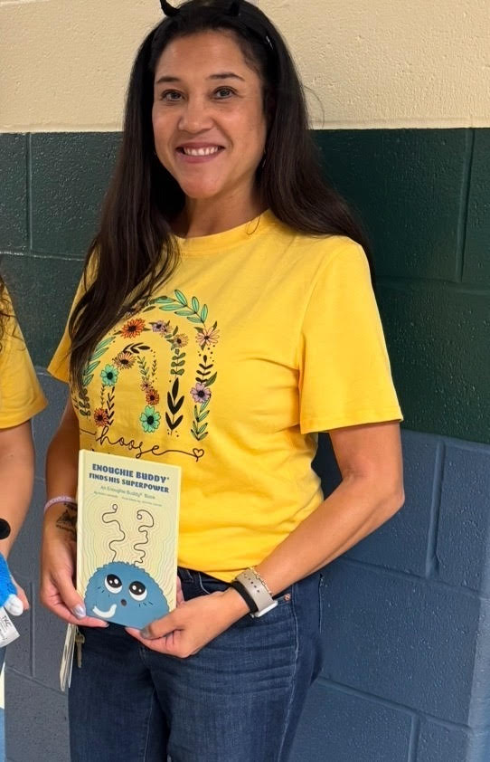 Our counselor and military liaison, Christine Camarillo posing with a book 