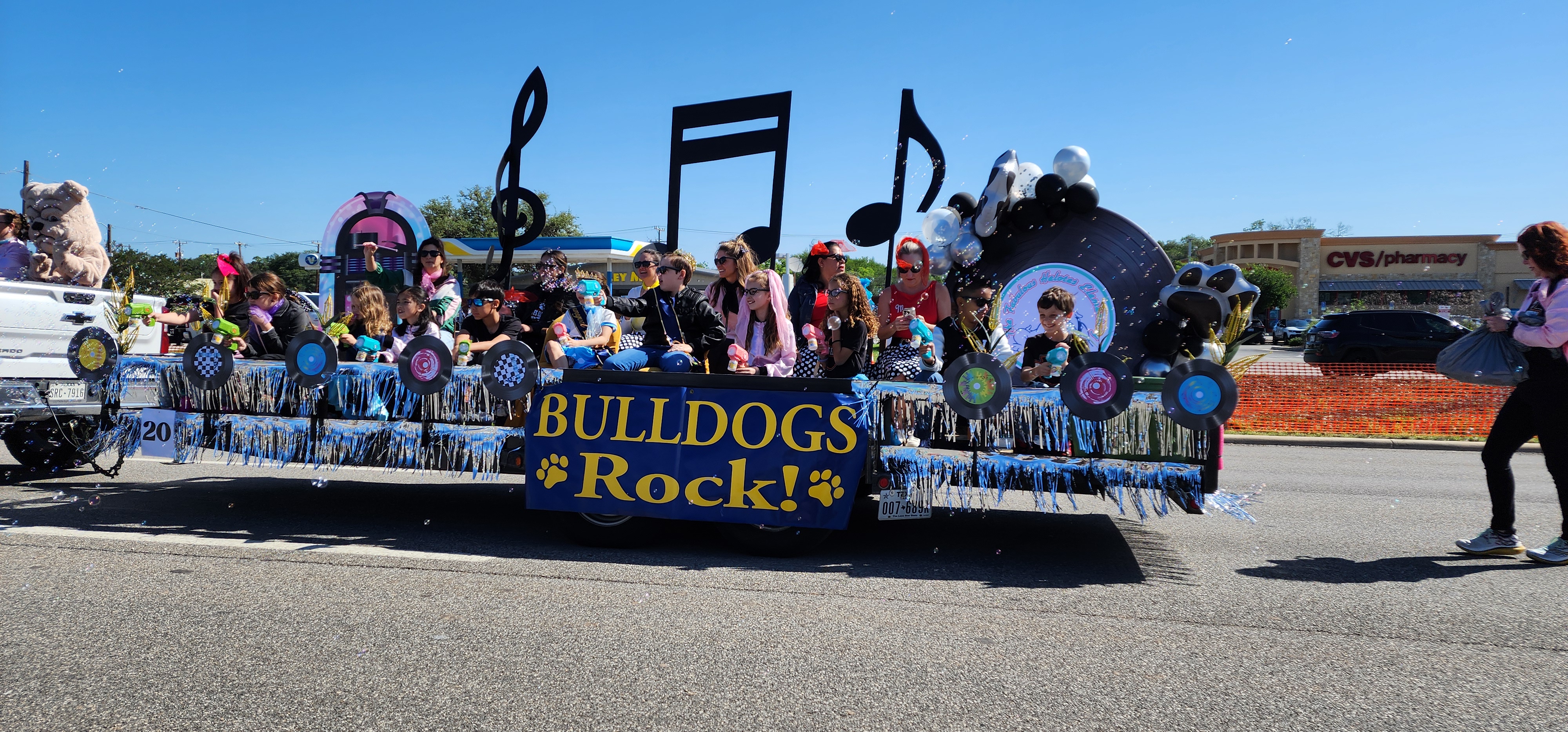Pic of Helotes Cornyval Parade with students and staff on it speading bubbles and cheer