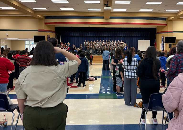 Carnahan families and a military veteran watch as our students perform the national anthem