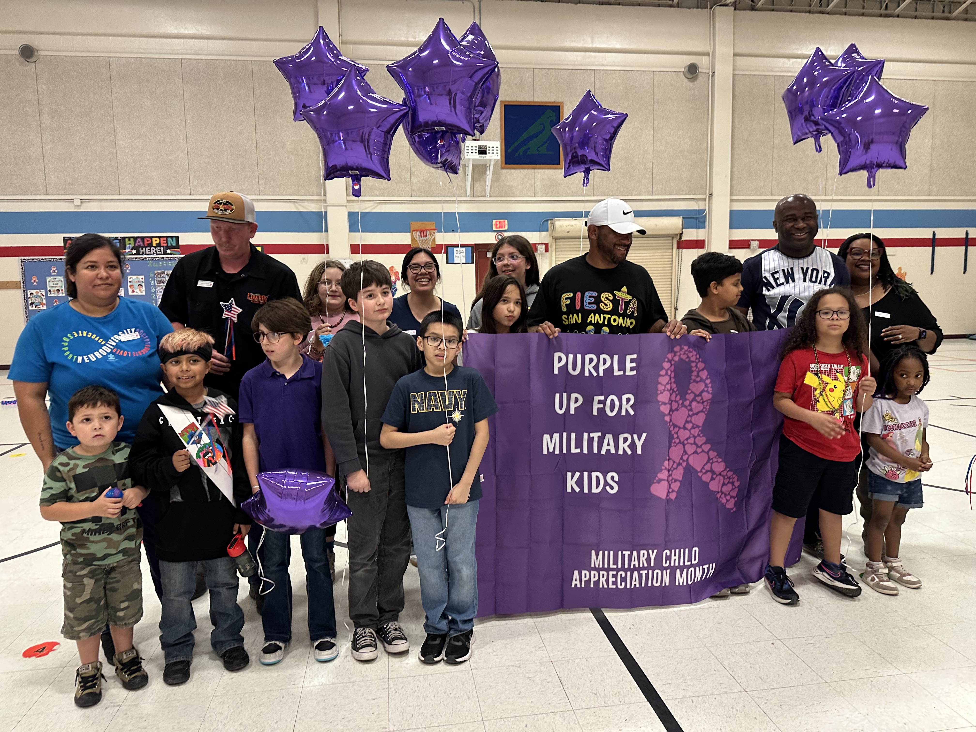 Our military kids club posing with Coach Goggins
