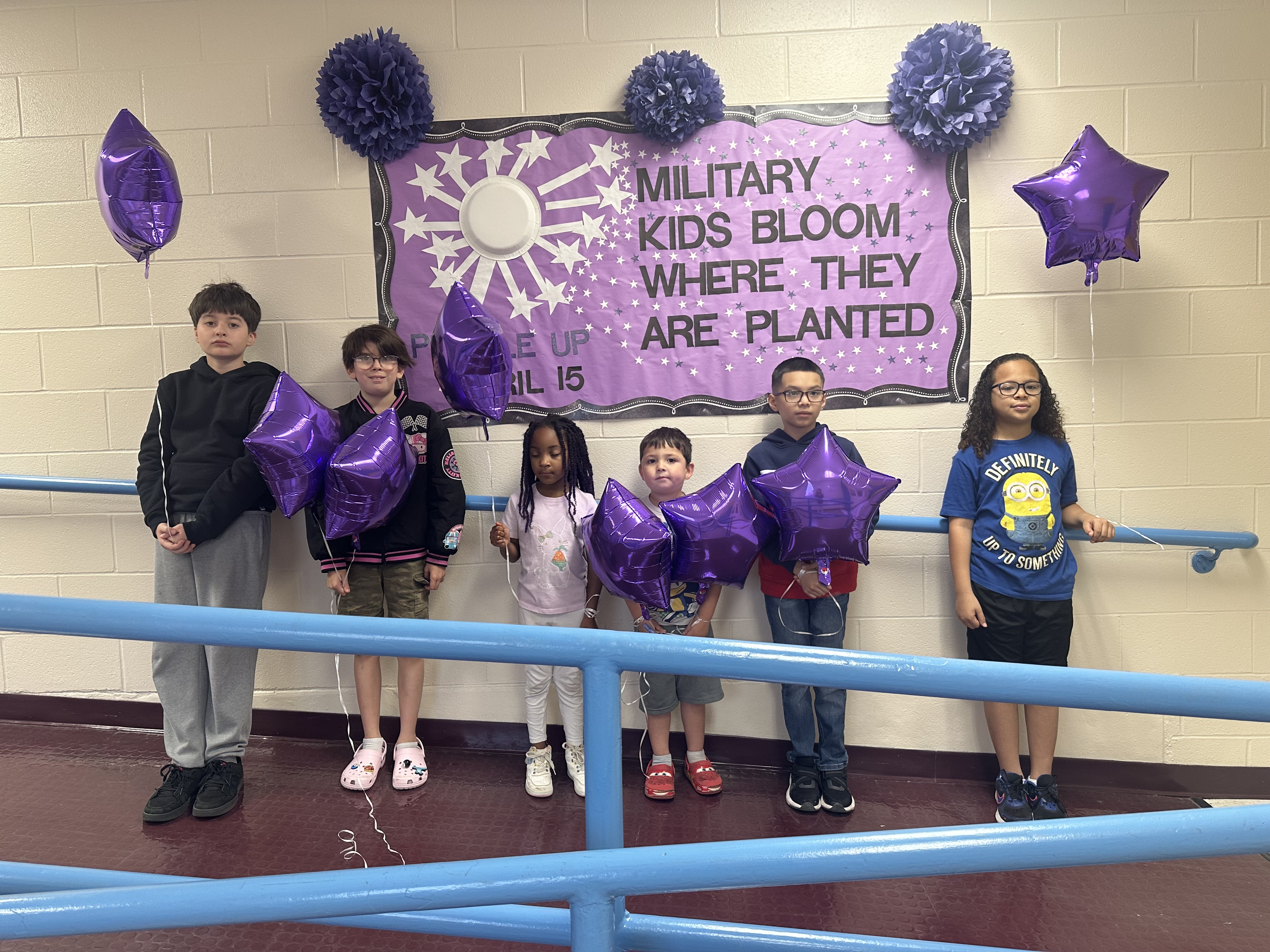 Our Military kids club posing with a sign