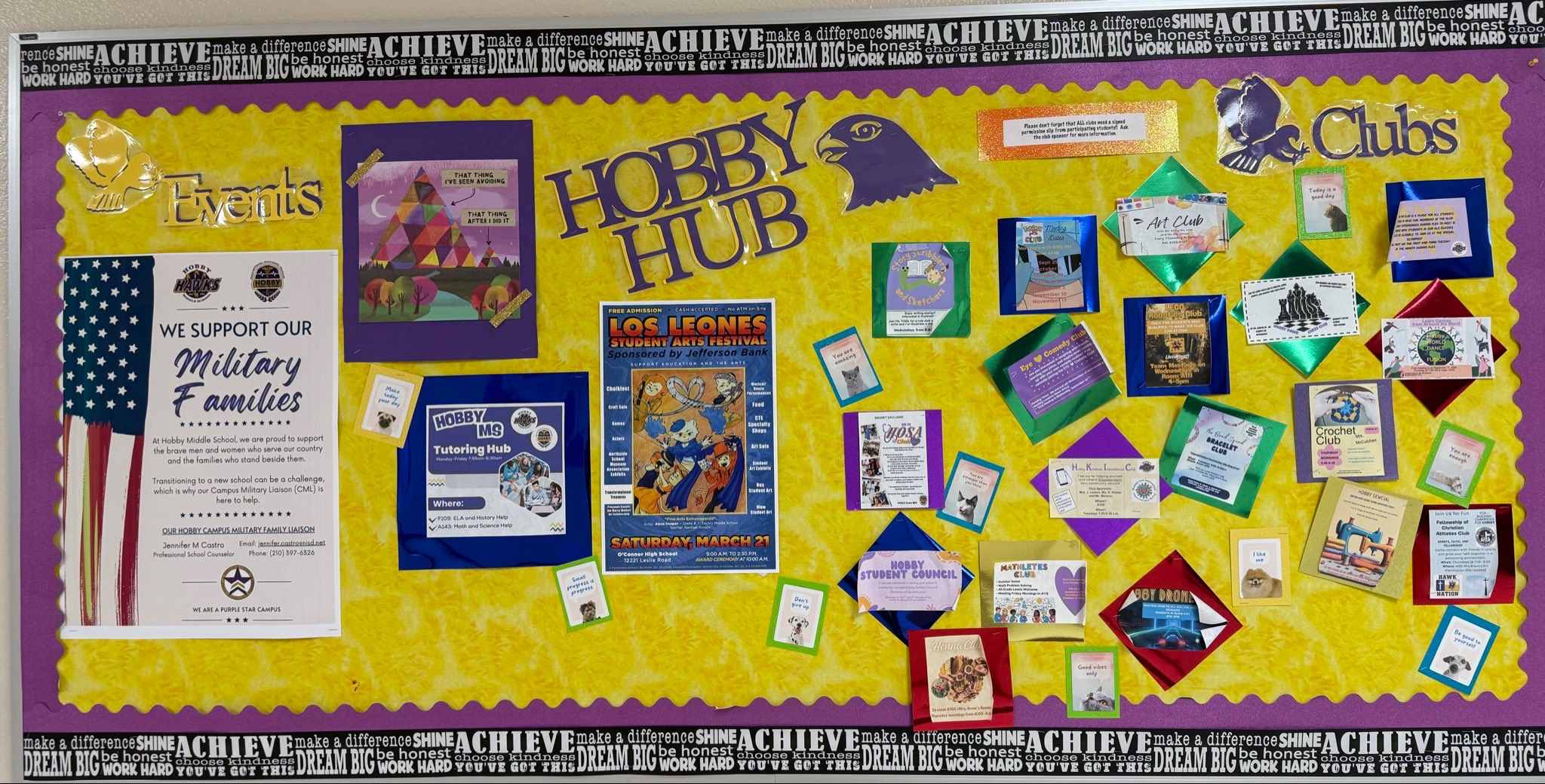 Picture of Hobby Middle Schools hobby hub. Wall of decorative yellow and purple with posters with clubs and activites with different color trimmings