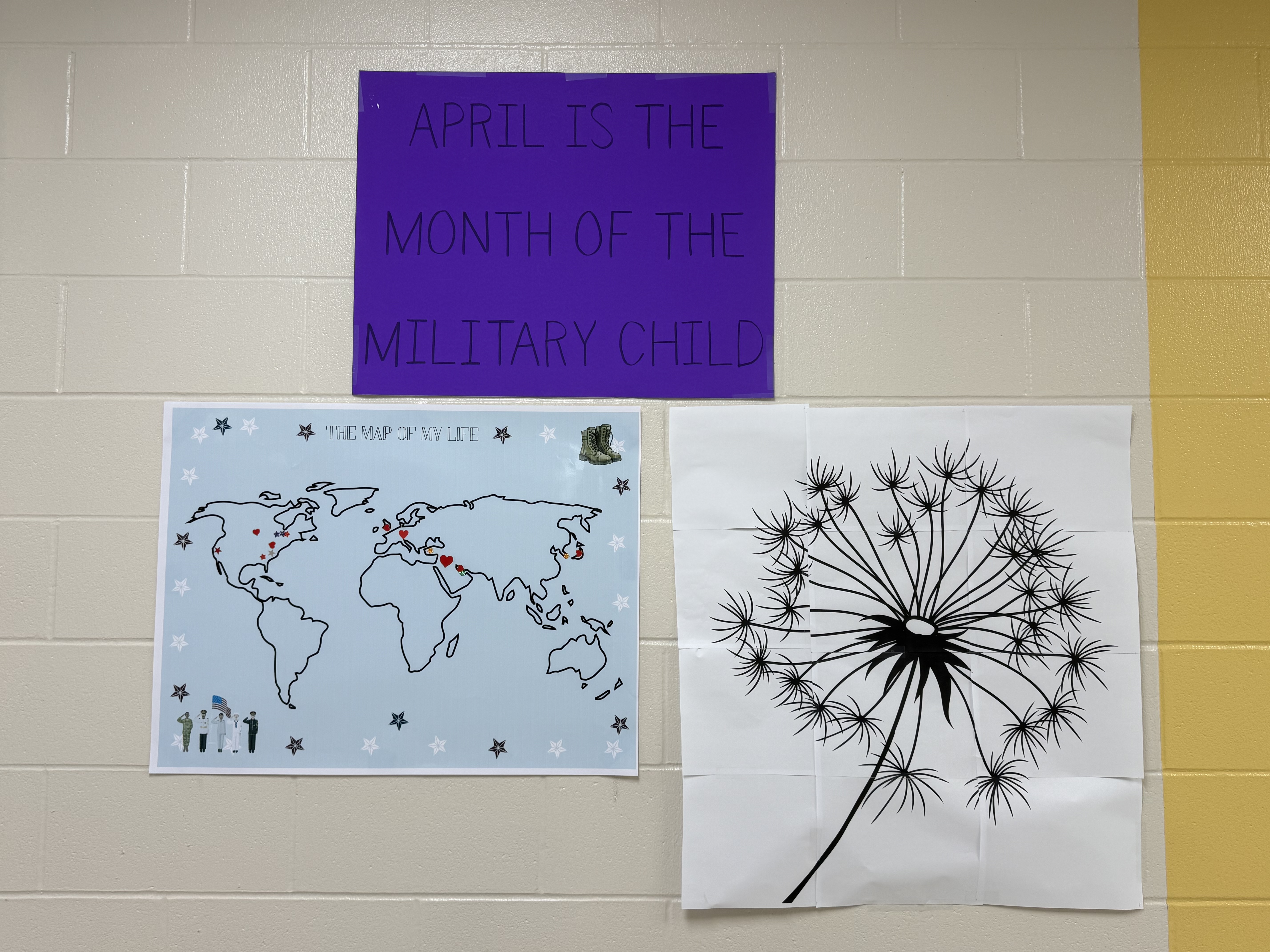 Picture of posters on a wall that have different ways of honoring month of the military child. One is a map and the other is a dandelion