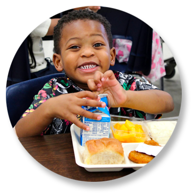 Student sitting at table with lunch tray