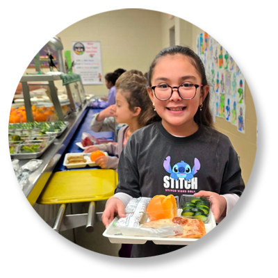 Student paying for lunch at the school cafeteria register.