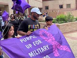 Our PE Coach and veteran, Coach Goggins leading the Purple Up Parade