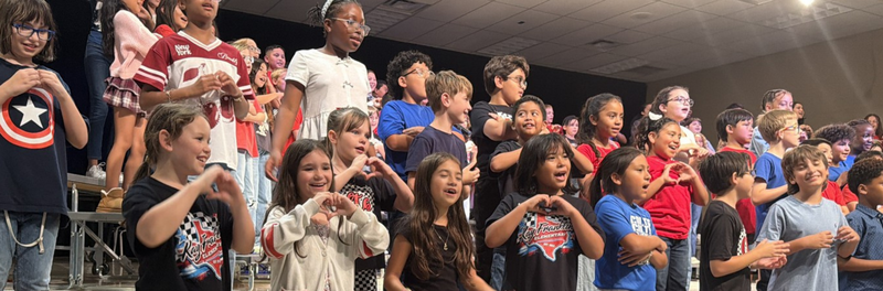 Students singing on stage