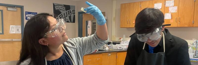 Students performing an experiment