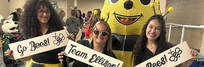 Ellison teachers holding signs that read go bees