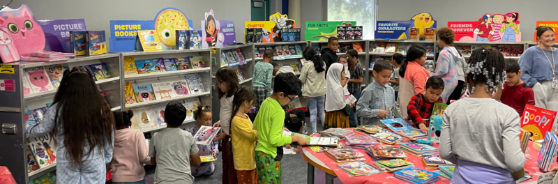 McDermott students shopping excitedly at the biannual book fair in the library