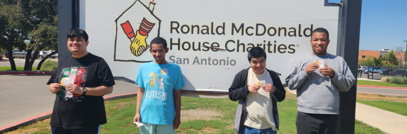 Reddix students posing in front of the Ronald McDonald House Charities sign