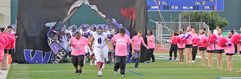 Pink Out Football Game pic with special friends leading the way.