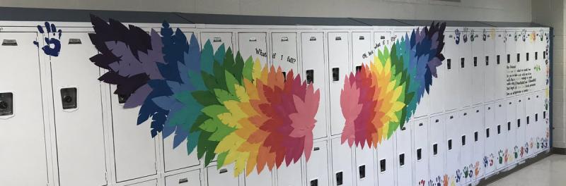 Rainbow wings and inspirational messages painted on student lockers