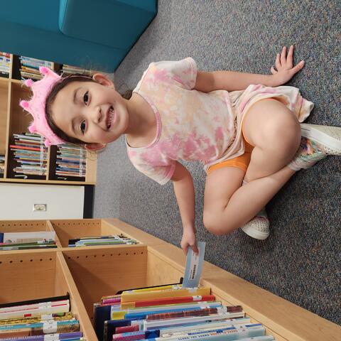Using a shelf marker to look for a book.