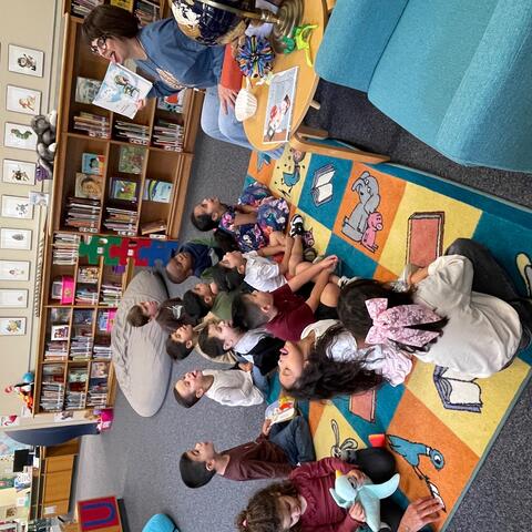 Ms. Mosley reading the book Just One Flake by Travis Jonker with a Pre-K class.