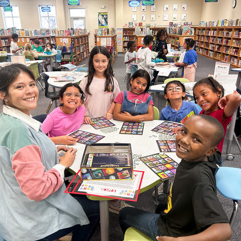 Students playing Lotería with their teacher in the Langley Library.