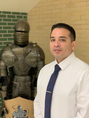 Principal Jose Mendez in front of black knight 