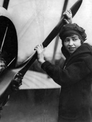 Katherine Stinson standing in front of her airplane