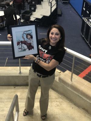 Principle Mrs. Siller holding a photo