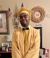 Domenic Dyer, Business Careers graduate poses in cap and gown