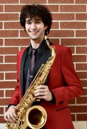 Gabriel Gonzalez posing with saxophone 
