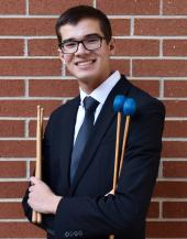 Gavin Patrick posing with drum sticks and mallets 