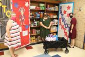 Principal, Counselor and Teacher stand in front of Patriot Pantry