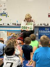 Trustee Carol Harle, Ph.D. reads