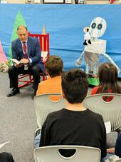 Trustee Dr. Homer Guevara, Jr. reads
