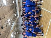 Jay HS Varsity Team players surrounding Jackson Gutierrez