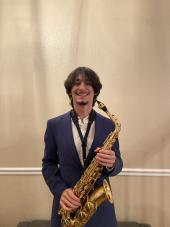 Zachary Levi Pena posing with Saxophone 