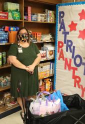 Principal stands in front of the Patriot Pantry